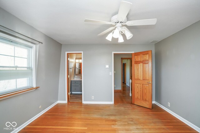 1310 Bowman Dr, Greenfield, IN 46140 - unfurnished bedroom featuring connected bathroom, baseboards, visible vents, and light wood finished floors