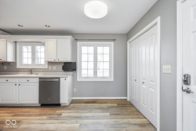 1310 Bowman Dr, Greenfield, IN 46140 - kitchen with a sink, stainless steel dishwasher, a wealth of natural light, and white cabinetry