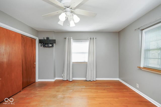 1310 Bowman Dr, Greenfield, IN 46140 - unfurnished bedroom featuring light wood-style flooring, baseboards, a closet, and ceiling fan