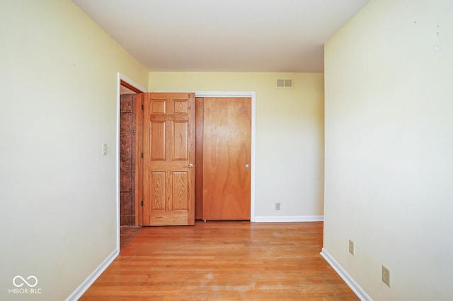 1310 Bowman Dr, Greenfield, IN 46140 - unfurnished bedroom featuring visible vents, baseboards, light wood-style floors, and a closet