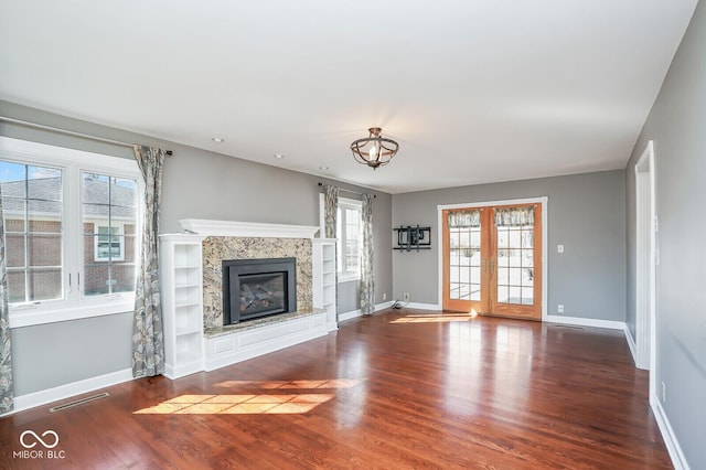 1310 Bowman Dr, Greenfield, IN 46140 - unfurnished living room featuring baseboards, wood finished floors, visible vents, and a premium fireplace