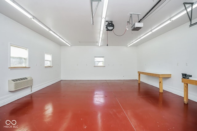 1310 Bowman Dr, Greenfield, IN 46140 - garage with baseboards, an AC wall unit, and a garage door opener