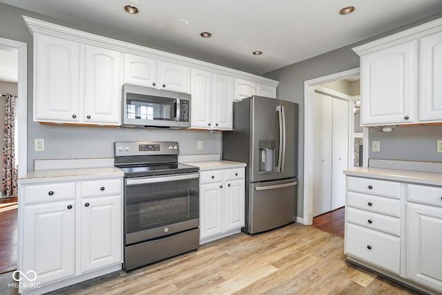 1310 Bowman Dr, Greenfield, IN 46140 - kitchen with light wood-style floors, appliances with stainless steel finishes, and white cabinets