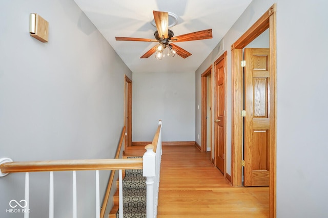 1310 Bowman Dr, Greenfield, IN 46140 - hall with visible vents, an upstairs landing, light wood-type flooring, and baseboards