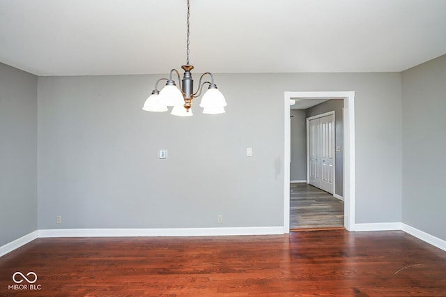 1310 Bowman Dr, Greenfield, IN 46140 - unfurnished room featuring baseboards, an inviting chandelier, and wood finished floors