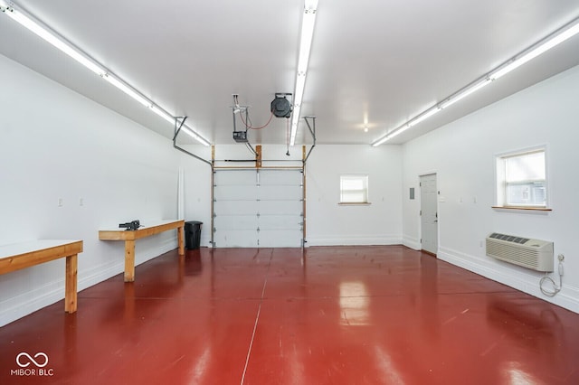 1310 Bowman Dr, Greenfield, IN 46140 - garage featuring a wall mounted air conditioner, baseboards, and a garage door opener