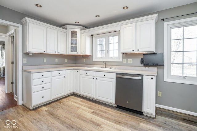 1310 Bowman Dr, Greenfield, IN 46140 - kitchen featuring dishwasher, light countertops, light wood-style floors, and a sink