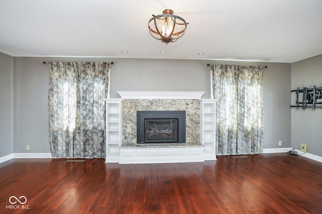 1310 Bowman Dr, Greenfield, IN 46140 - unfurnished living room featuring a premium fireplace, baseboards, and wood finished floors
