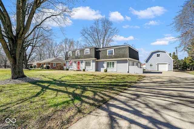 1310 Bowman Dr, Greenfield, IN 46140 - view of front of property with a front yard, mansard roof, a shingled roof, an outdoor structure, and a garage