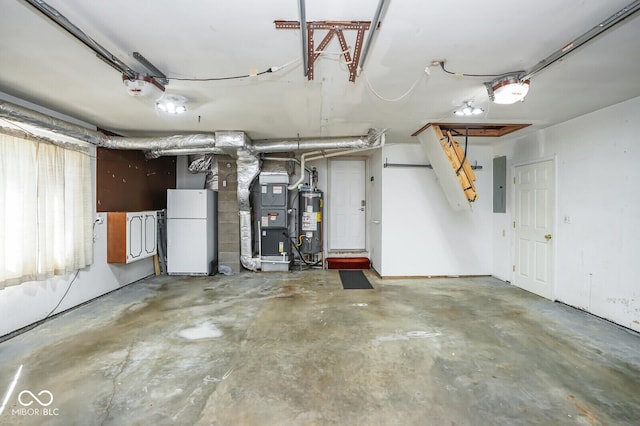 1310 Bowman Dr, Greenfield, IN 46140 - garage with heating unit, electric panel, water heater, and freestanding refrigerator