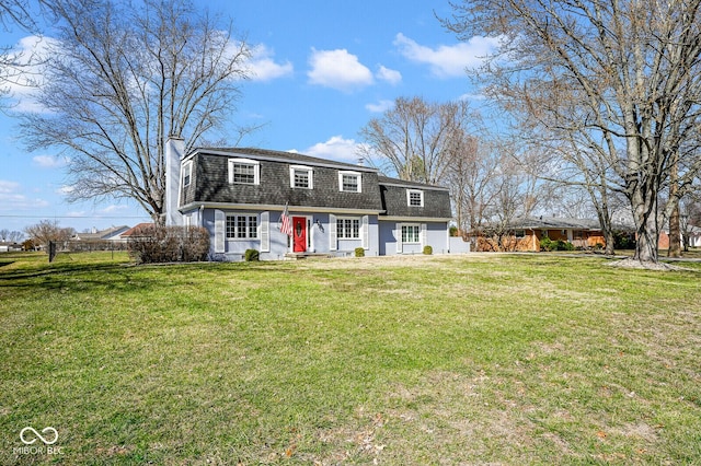 colonial inspired home with roof with shingles, a front lawn, and fence