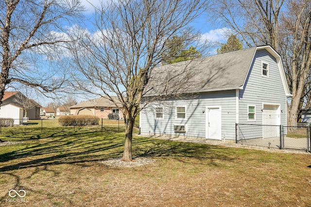 1310 Bowman Dr, Greenfield, IN 46140 - rear view of property featuring a yard, fence, a garage, and a gambrel roof