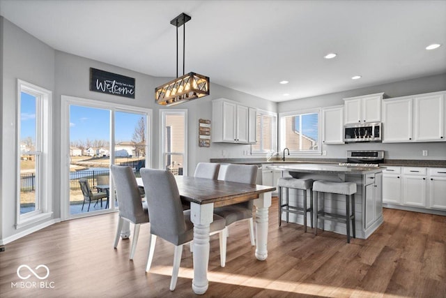 dining area featuring a wealth of natural light, recessed lighting, and dark wood-style flooring