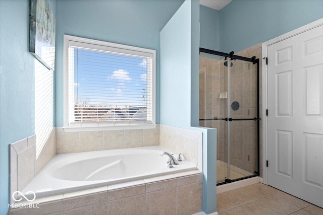 full bath featuring tile patterned floors, a garden tub, and a stall shower