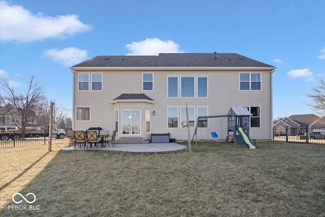 rear view of property with a patio, a playground, a lawn, and a fenced backyard