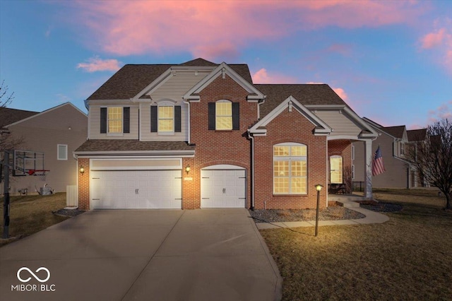 traditional home featuring brick siding, a lawn, an attached garage, and driveway