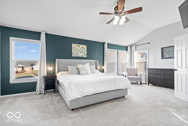 bedroom with ceiling fan, baseboards, lofted ceiling, and carpet floors