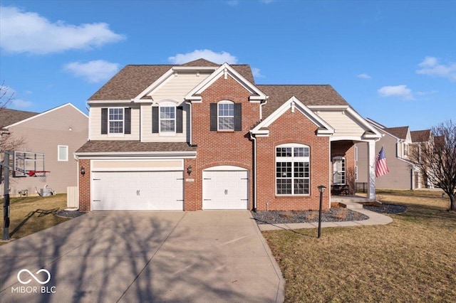 traditional home with a front yard, a shingled roof, concrete driveway, a garage, and brick siding