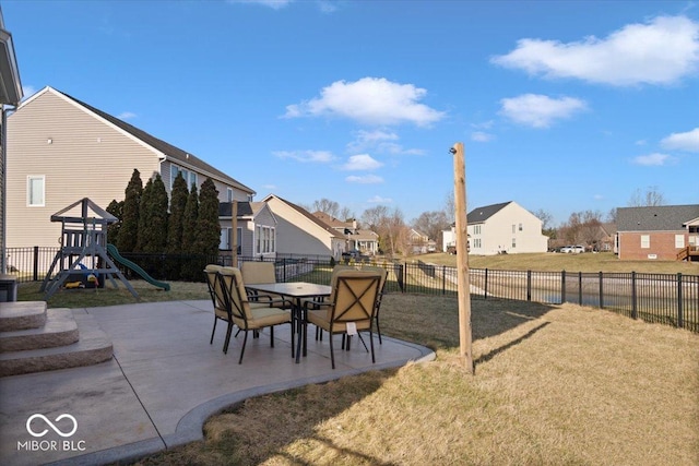 view of yard with a patio area, a playground, a fenced backyard, and a residential view