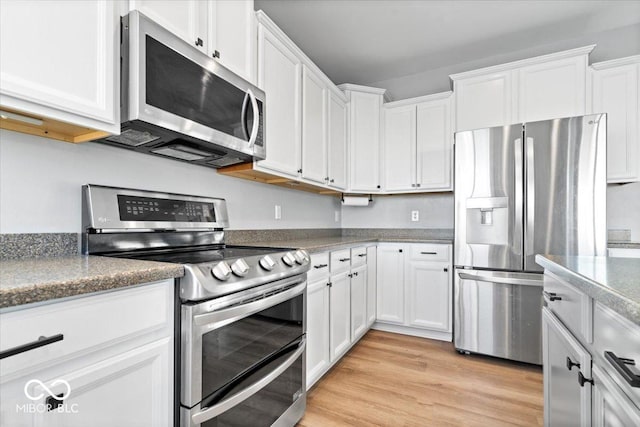 kitchen with light wood finished floors, white cabinetry, and stainless steel appliances