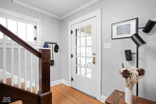 5426 Broadway St, Indianapolis, IN 46220 - foyer featuring crown molding, baseboards, stairway, and light wood-style floors