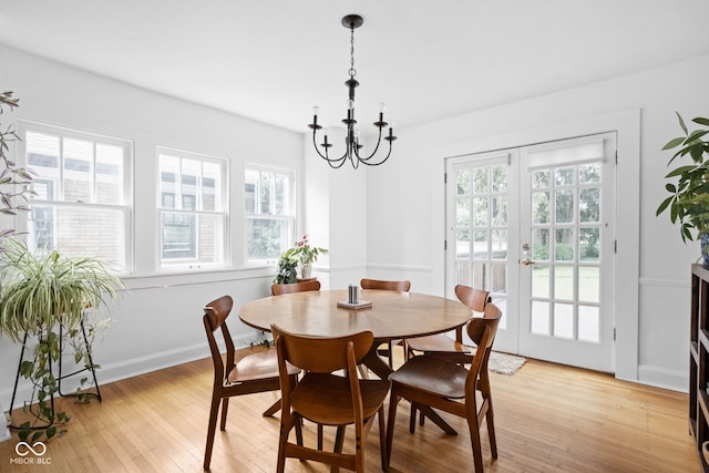 5426 Broadway St, Indianapolis, IN 46220 - dining area with a chandelier, light wood-style floors, and baseboards