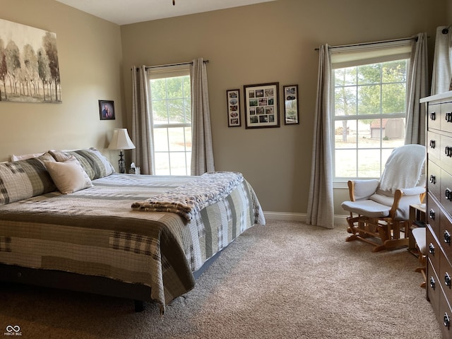 bedroom with baseboards and carpet floors