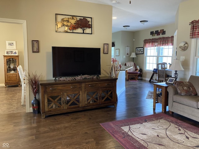 living area with baseboards and wood finished floors