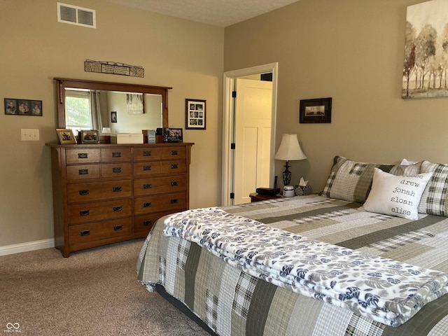 carpeted bedroom with visible vents and baseboards