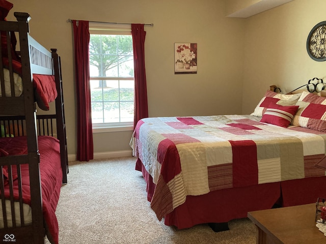 bedroom with baseboards and carpet floors