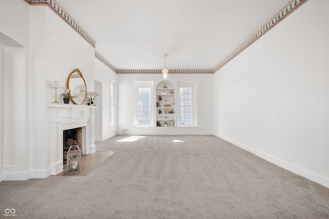 unfurnished living room featuring a fireplace with flush hearth, baseboards, and carpet floors