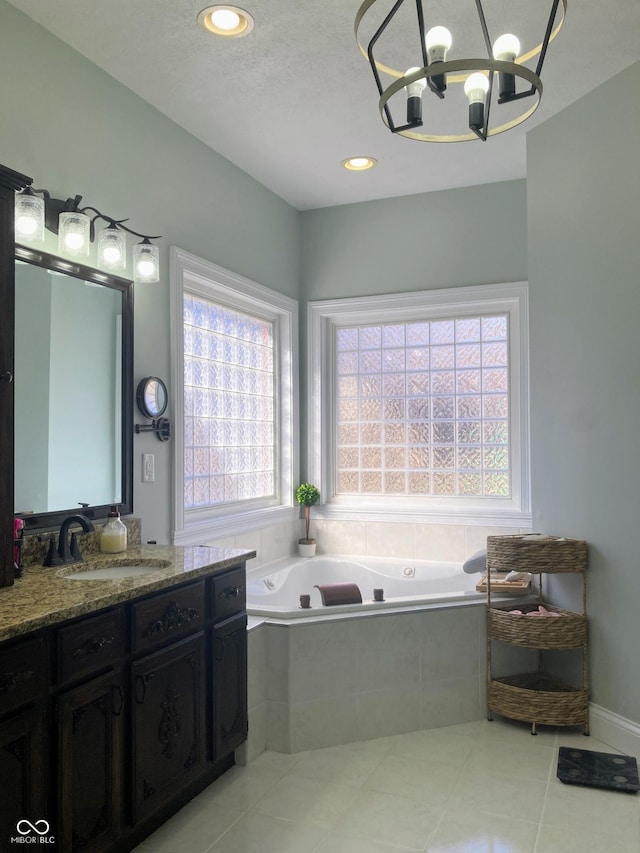 bathroom featuring a notable chandelier, a garden tub, recessed lighting, tile patterned flooring, and vanity