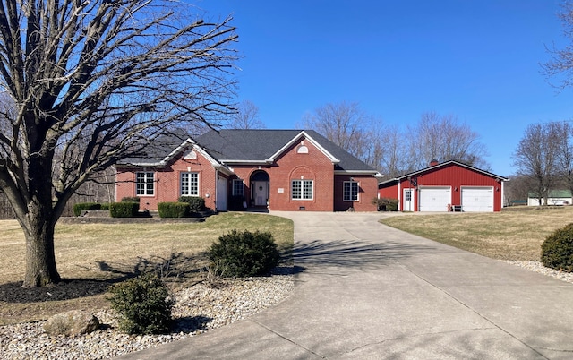 view of front of house featuring a front yard, concrete driveway, an outdoor structure, a garage, and brick siding