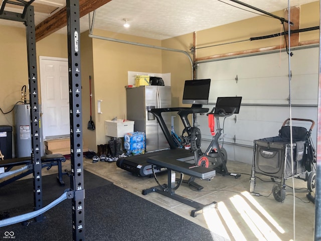 workout room featuring a garage and water heater