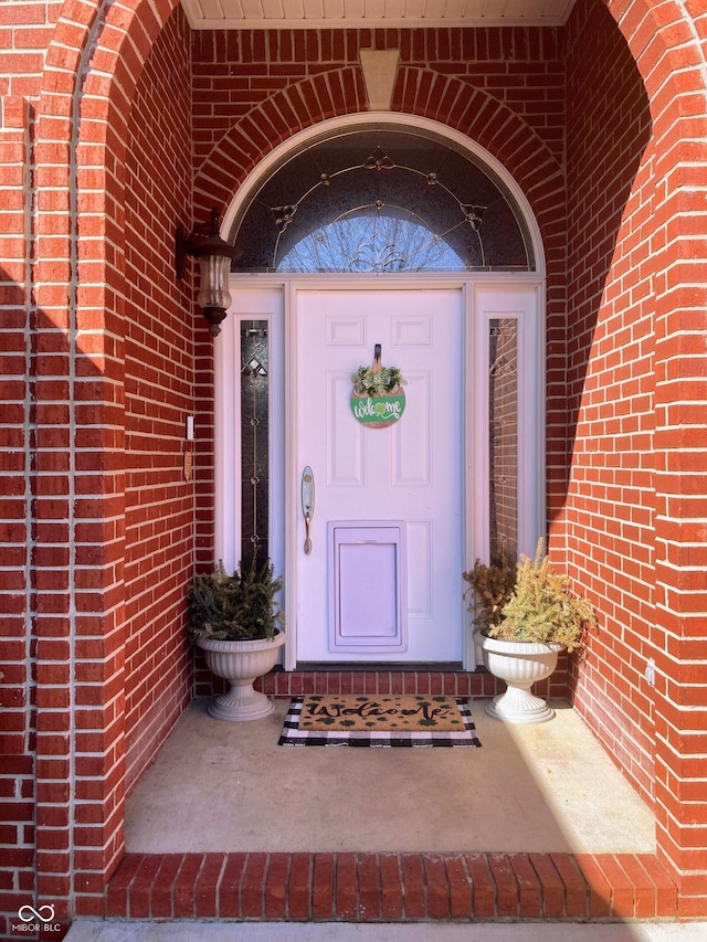 entrance to property with brick siding