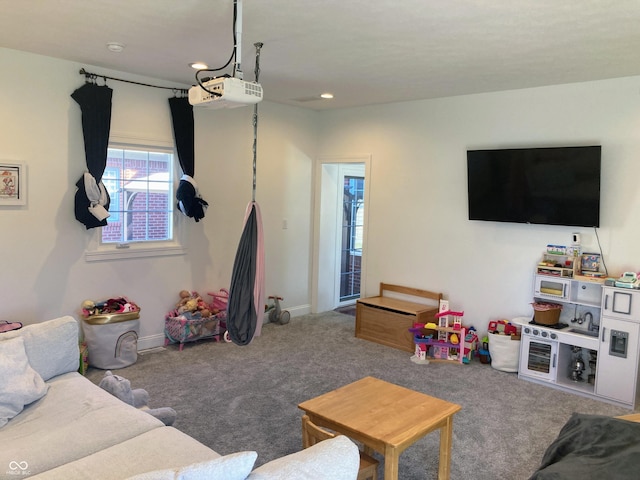 carpeted living area with recessed lighting and baseboards