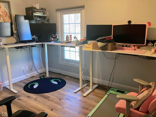 home office featuring visible vents, baseboards, and wood finished floors