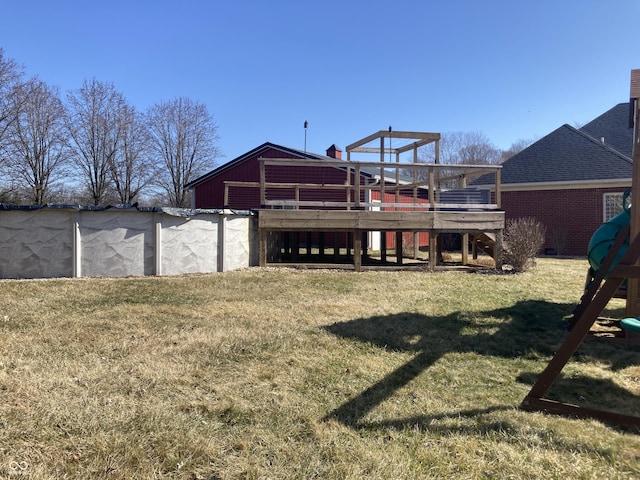 back of house featuring brick siding, a yard, and roof with shingles