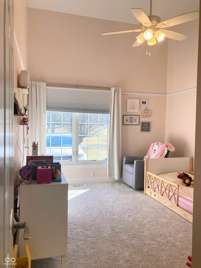 bedroom with a ceiling fan and carpet