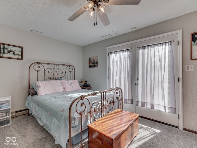 carpeted bedroom with a baseboard heating unit, a textured ceiling, a ceiling fan, and a textured wall