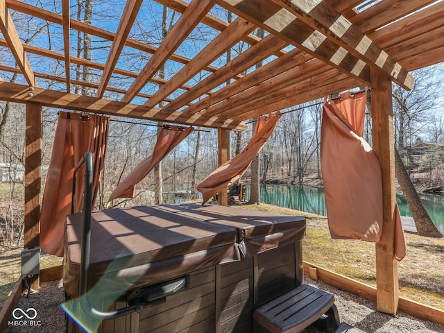 exterior space with a hot tub and a water view