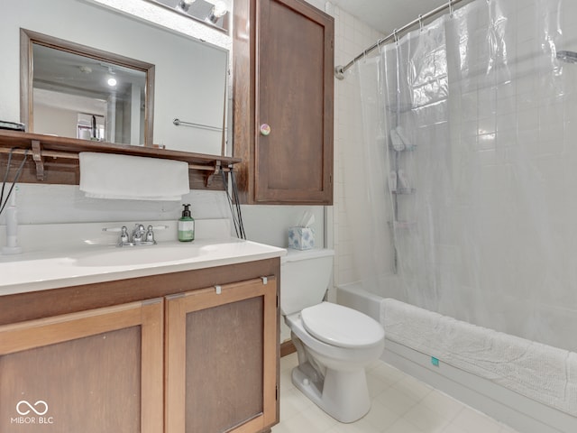 bathroom featuring shower / bath combo with shower curtain, toilet, and vanity