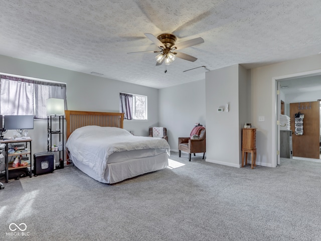 bedroom featuring baseboards, a textured ceiling, ceiling fan, and carpet floors