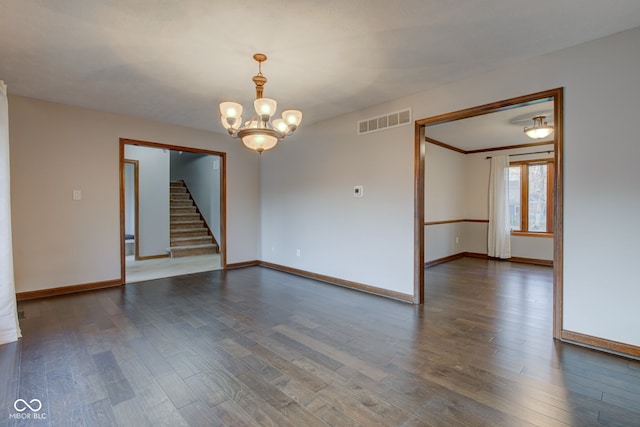 spare room featuring visible vents, baseboards, stairs, a notable chandelier, and dark wood-style flooring