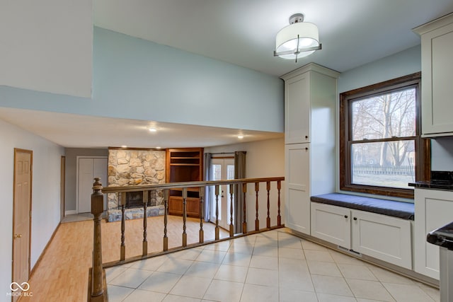 kitchen with light tile patterned floors and dark countertops