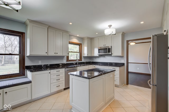 kitchen with light tile patterned floors, stainless steel appliances, recessed lighting, and a sink