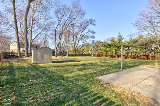 view of yard featuring a fenced backyard, a patio, a storage unit, and an outdoor structure