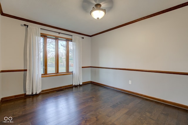 unfurnished room with baseboards, dark wood-style floors, and ornamental molding