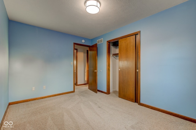 unfurnished bedroom featuring a closet, visible vents, carpet, and baseboards