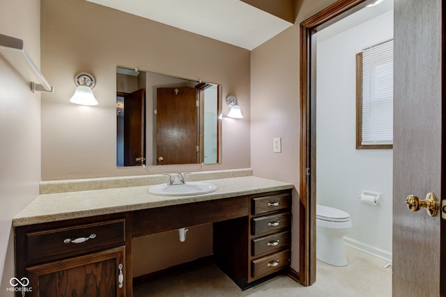 bathroom featuring baseboards, toilet, and vanity